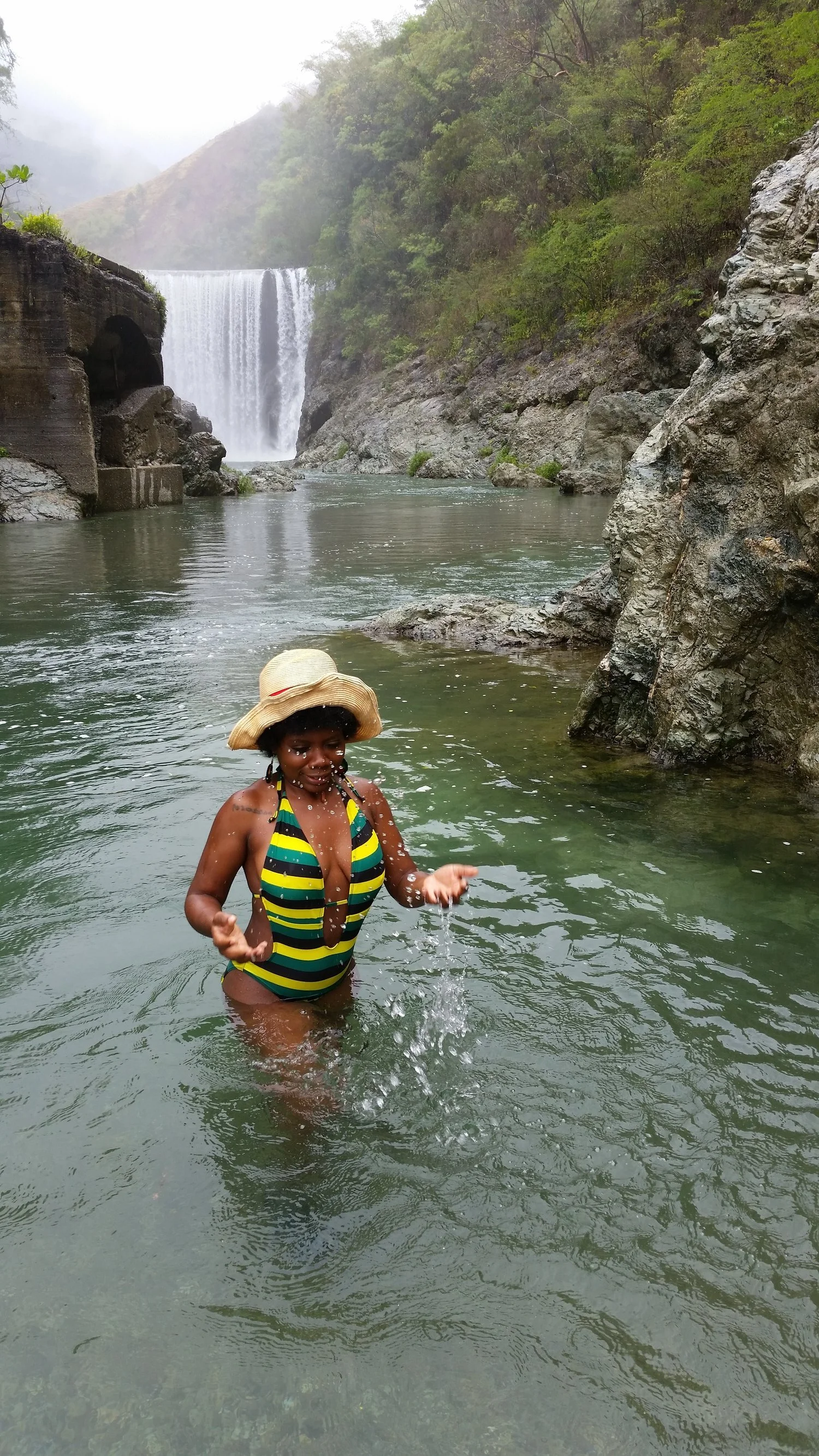 Visitor swimming at Reggae Falls in St. Thomas Jamaica